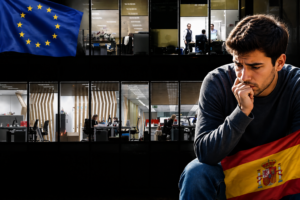 Joven preocupado frente a oficinas en España con banderas de Europa, reflejando la incertidumbre sobre el empleo y la economía